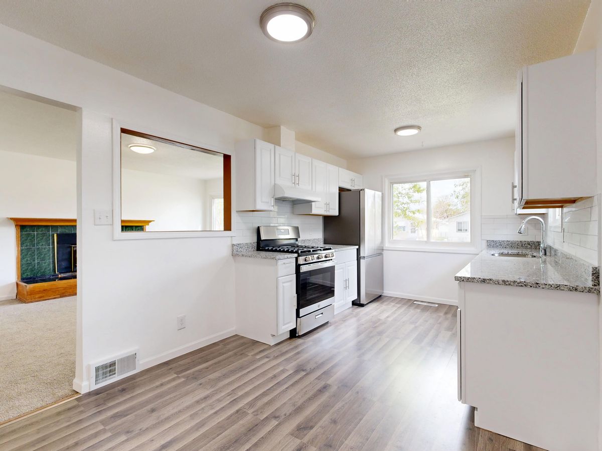 Bright finished kitchen renovation with white cabinets and hardwood floors in a GTA home